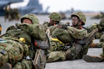 Paratroopers from the Japan Ground Self-Defense Force, 1st Airborne Brigade, wait to load onto a C-130J Super Hercules assigned to the 36th Airlift Squadron at Yokota Air Base, Japan, March 3, 2025.