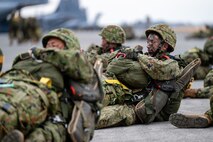 Paratroopers from the Japan Ground Self-Defense Force, 1st Airborne Brigade, wait to load onto a C-130J Super Hercules assigned to the 36th Airlift Squadron at Yokota Air Base, Japan, March 3, 2025.