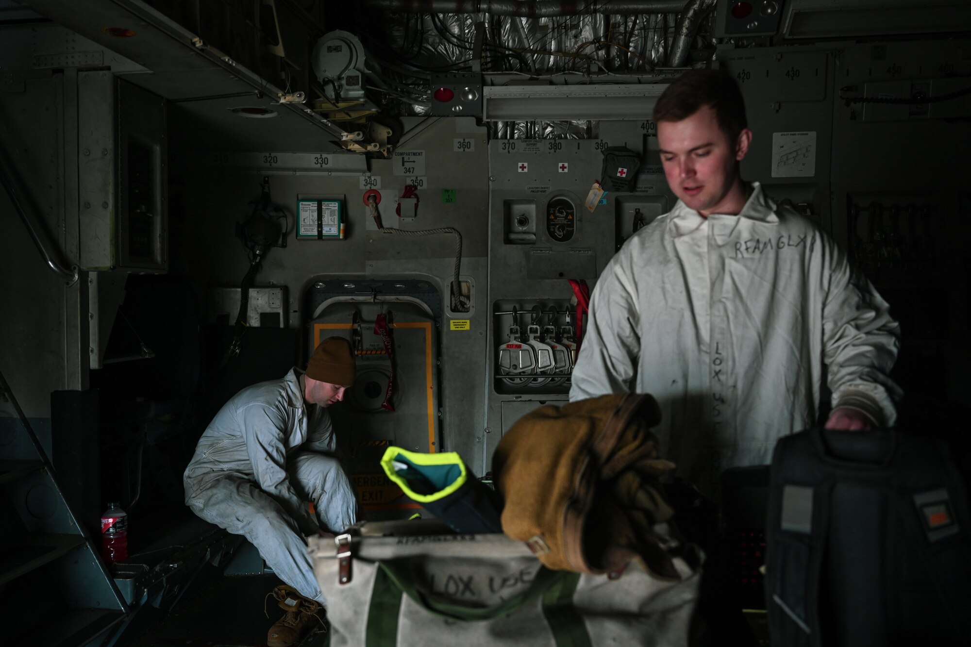 Staff Sgt. James Sullivan, left, a 726th Air Mobility Squadron C-17A Globemaster III crew chief, and Staff Sgt. Terry McGivern, a 726 AMS heavy integrated avionics craftsman, don personal protective equipment prior to carrying out liquid oxygen servicing on a C-17A Globemaster III on Ramstein Air Base, Germany, Feb. 26, 2025.