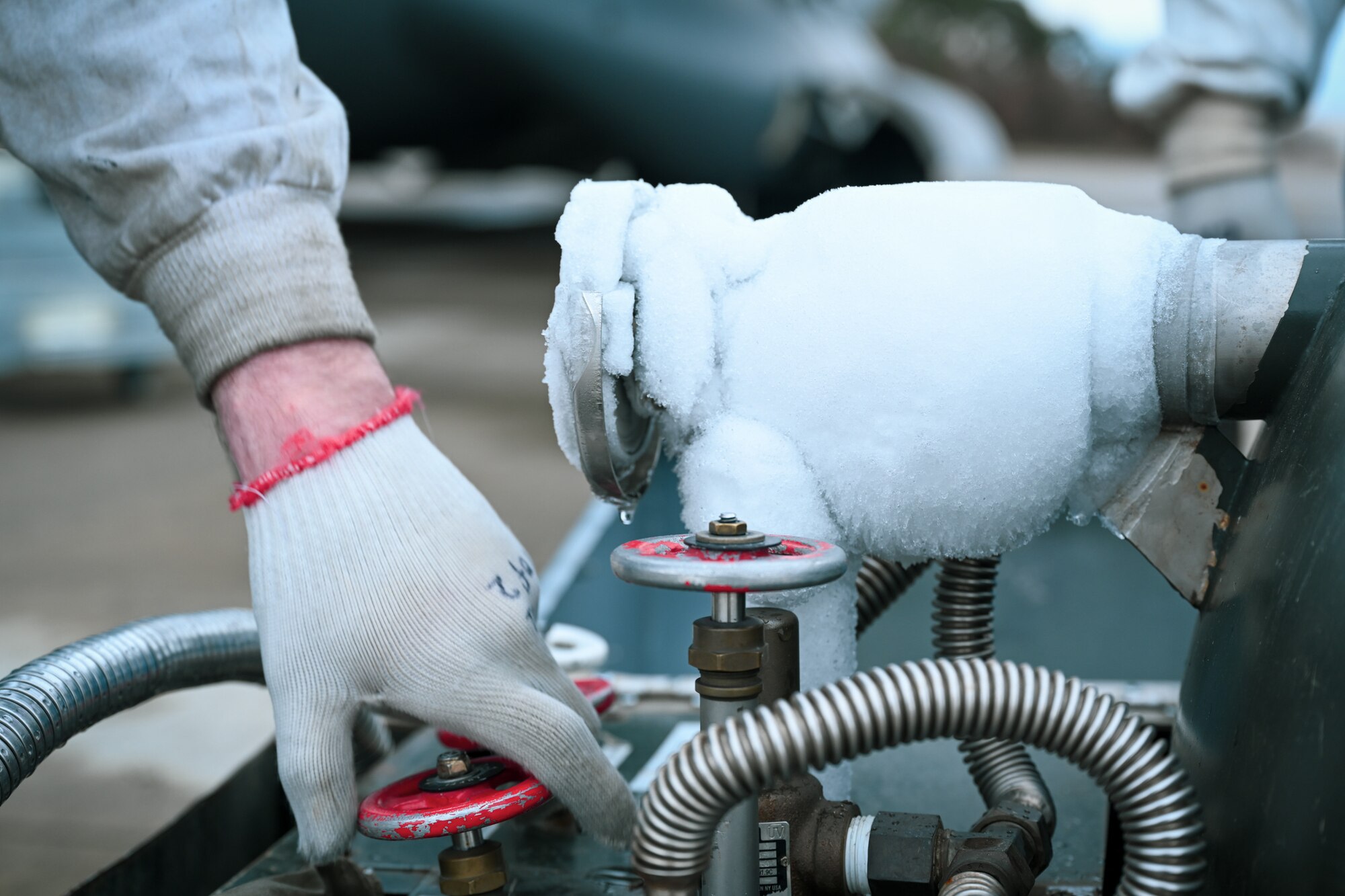 Staff Sgt. James Sullivan, a 726th Air Mobility Squadron C-17A Globemaster III crew chief, ensures a valve is closed on a liquid oxygen servicing cart prior to repositioning it next to a C-17A Globemaster III. on Ramstein Air Base, Germany, Feb. 26, 2025.