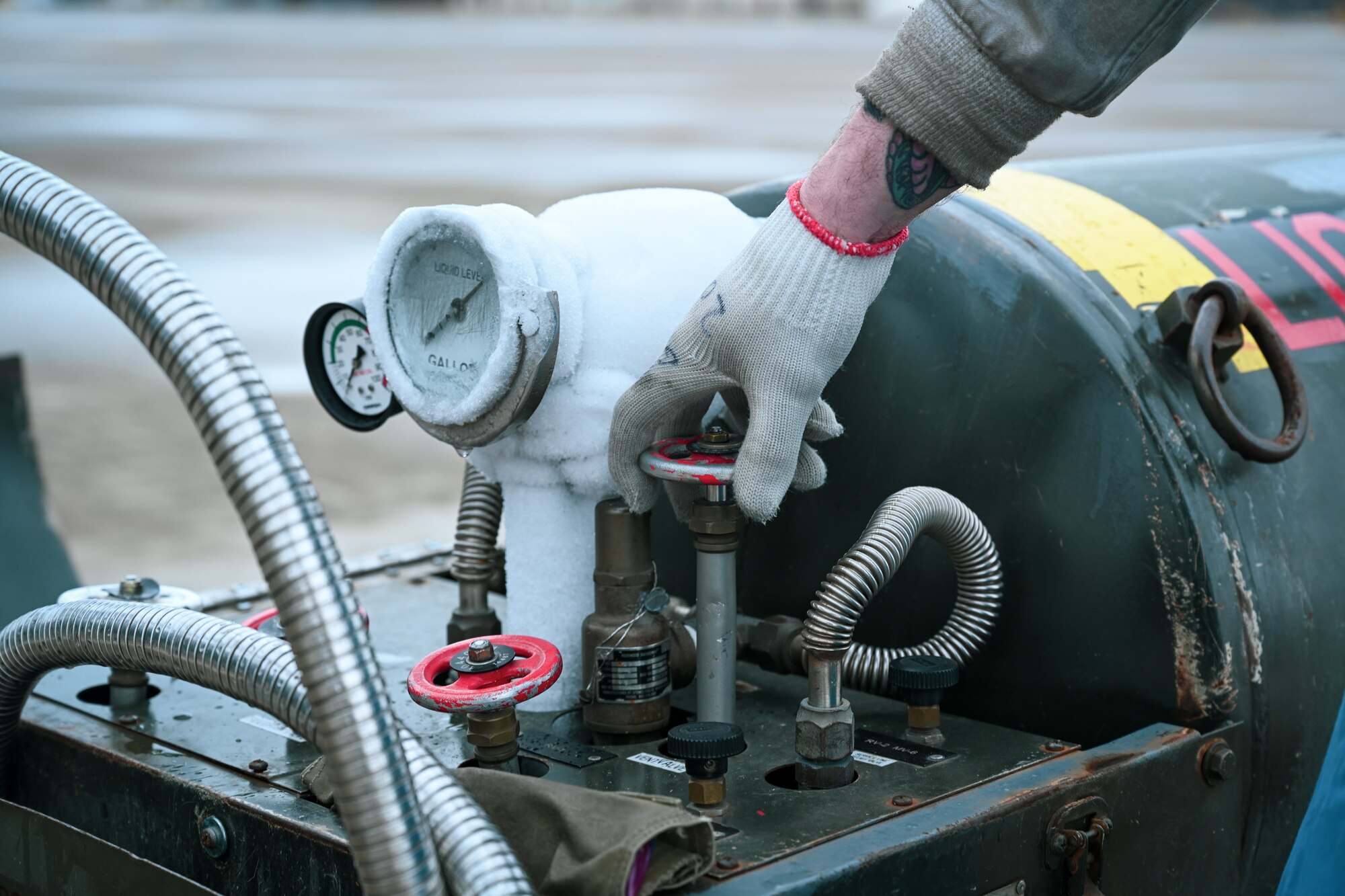 Staff Sgt. James Sullivan, a 726th Air Mobility Squadron C-17A Globemaster III crew chief, ensures a valve is closed on a liquid oxygen servicing cart prior to repositioning it next to a C-17A Globemaster III on Ramstein Air Base, Germany, Feb. 26, 2025.