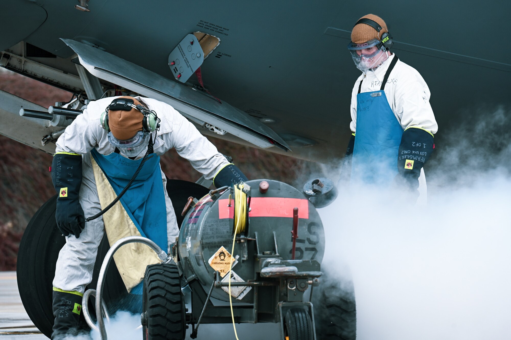 Staff Sgt. James Sullivan, left, a 726th Air Mobility Squadron C-17A Globemaster III crew chief, and Staff Sgt. Terry McGivern, a 726 AMS heavy integrated avionics craftsman, purge a liquid oxygen service hose before connecting it to a C-17A Globemaster III aircraft on Ramstein Air Base, Germany, Feb. 26, 2025.