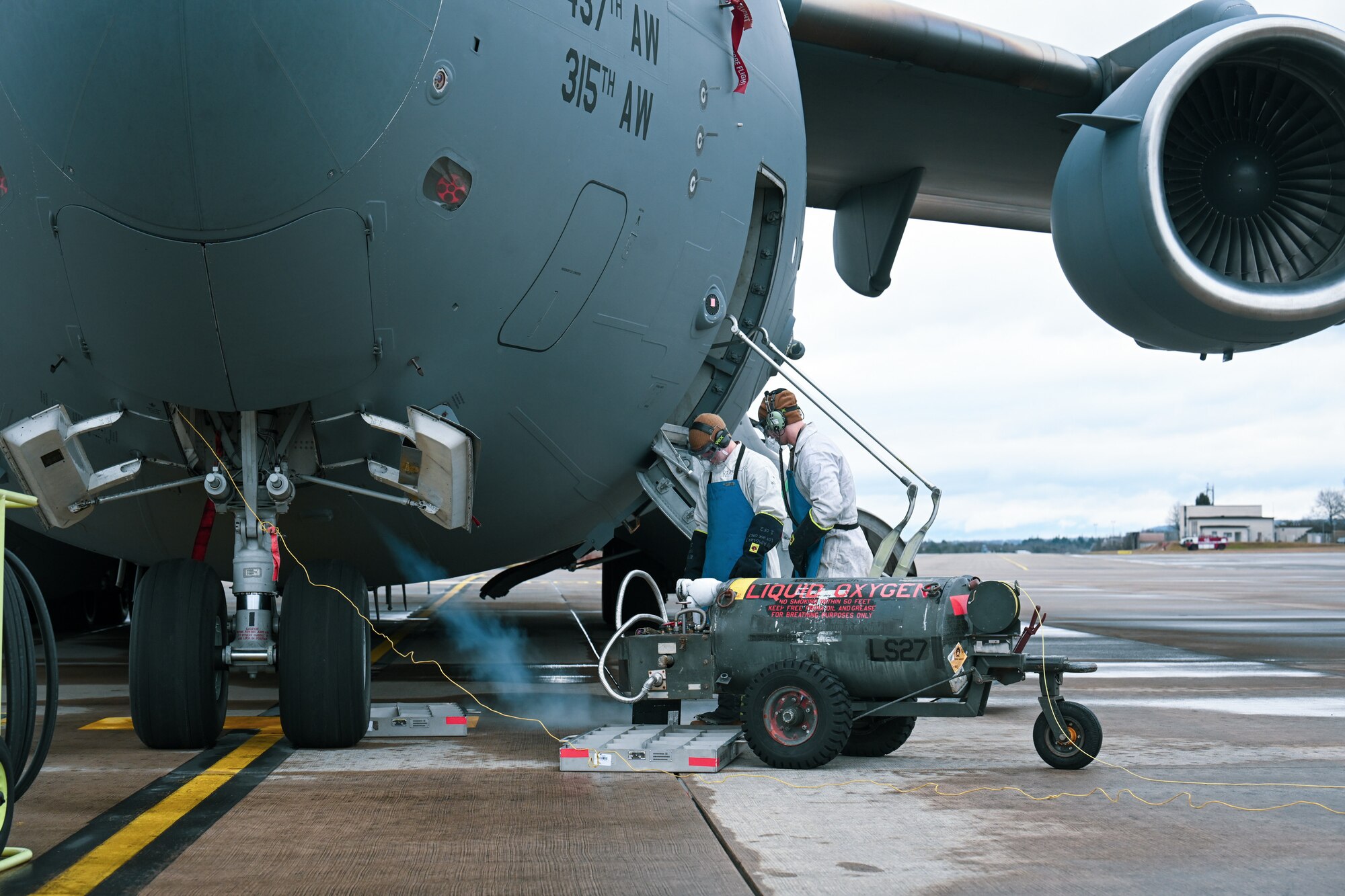 Both Staff Sgt. James Sullivan, right, a 726th Air Mobility Squadron C-17A Globemaster III crew chief, and Staff Sgt. Terry McGivern, a 726 AMS heavy integrated avionics craftsman, vent one of the three liquid oxygen converters, prior to servicing on a C-17A Globemaster III on Ramstein Air Base, Germany, Feb. 26, 2025.