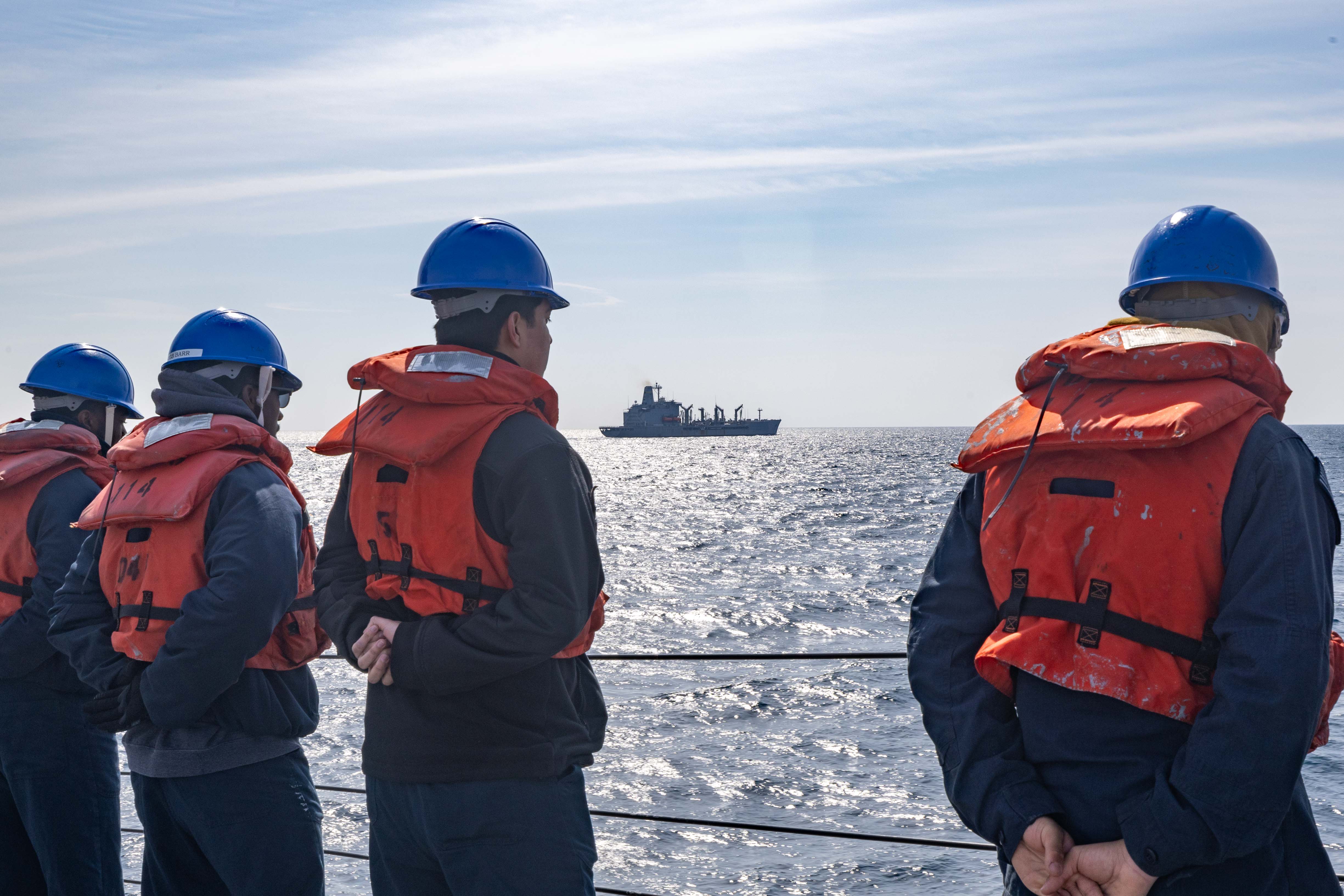 SEA OF JAPAN (March 10, 2025) – Sailors assigned to the Arleigh Burke-class guided-missile destroyer USS Ralph Johnson (DDG 114) fall into port side during a replenishment-at-sea with the Henry J. Kaiser-class underway replenishment oiler USNS Guadalupe (T-AO 200) while underway in the Sea of Japan, March 10. Commander, Logistics Group Western Pacific/Task Force 73 logistically resupplies deployed units in the Indo-Pacific along with regional Allies and partners. Ralph Johnson is forward deployed and assigned to Destroyer Squadron (DESRON) 15, the Navy’s largest DESRON and the U.S. 7th fleet’s principal surface force. (U.S. Navy photo by Mass Communication Specialist 1st Class Hannah Fry)