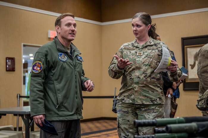U.S. Air Force Col. Paul Davidson, left, 35th Fighter Wing commander, and Capt. Kadeesh McNaught, 35th Force Support Squadron Emergency Evacuation Program (EEP) officer in charge, discusses operations during an EEP exercise at Misawa Air Base, Japan, Mar. 11, 2025.