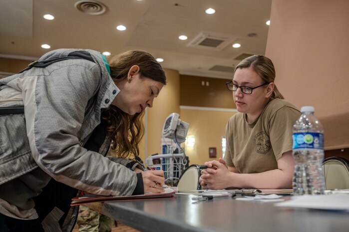 An Eligible Family Member participant in-processes with medical during an Emergency Evacuation Program (EEP) exercise at Misawa Air Base, Japan, Mar. 11, 2025.