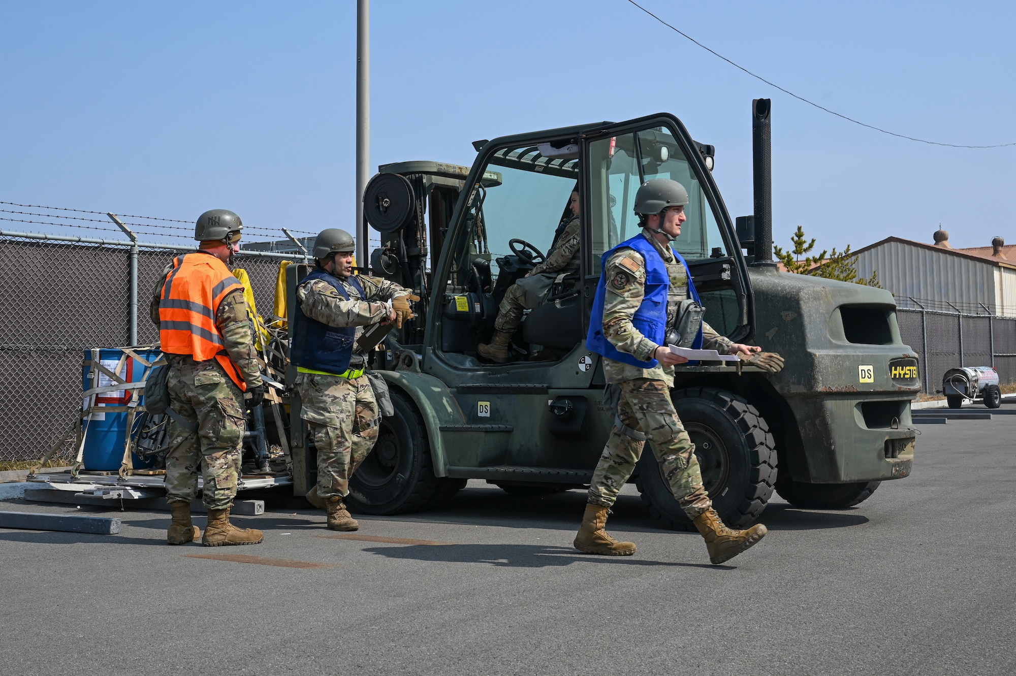 Airmen assigned to the 8th Logistics Readiness Squadron prepare to load cargo from a vehicle during a cargo deployment function line during Freedom Shield 25.