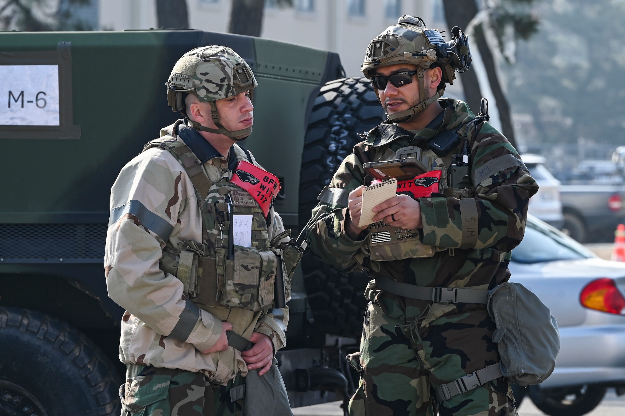 U.S. Air Force Tech. Sgt. Daniel Elmore, left, and Tech. Sgt. Rafael Mauricio, 8th Security Forces Squadron Wing Inspection Team members, discuss and evaluate ground attack procedures during Freedom Shield 25.