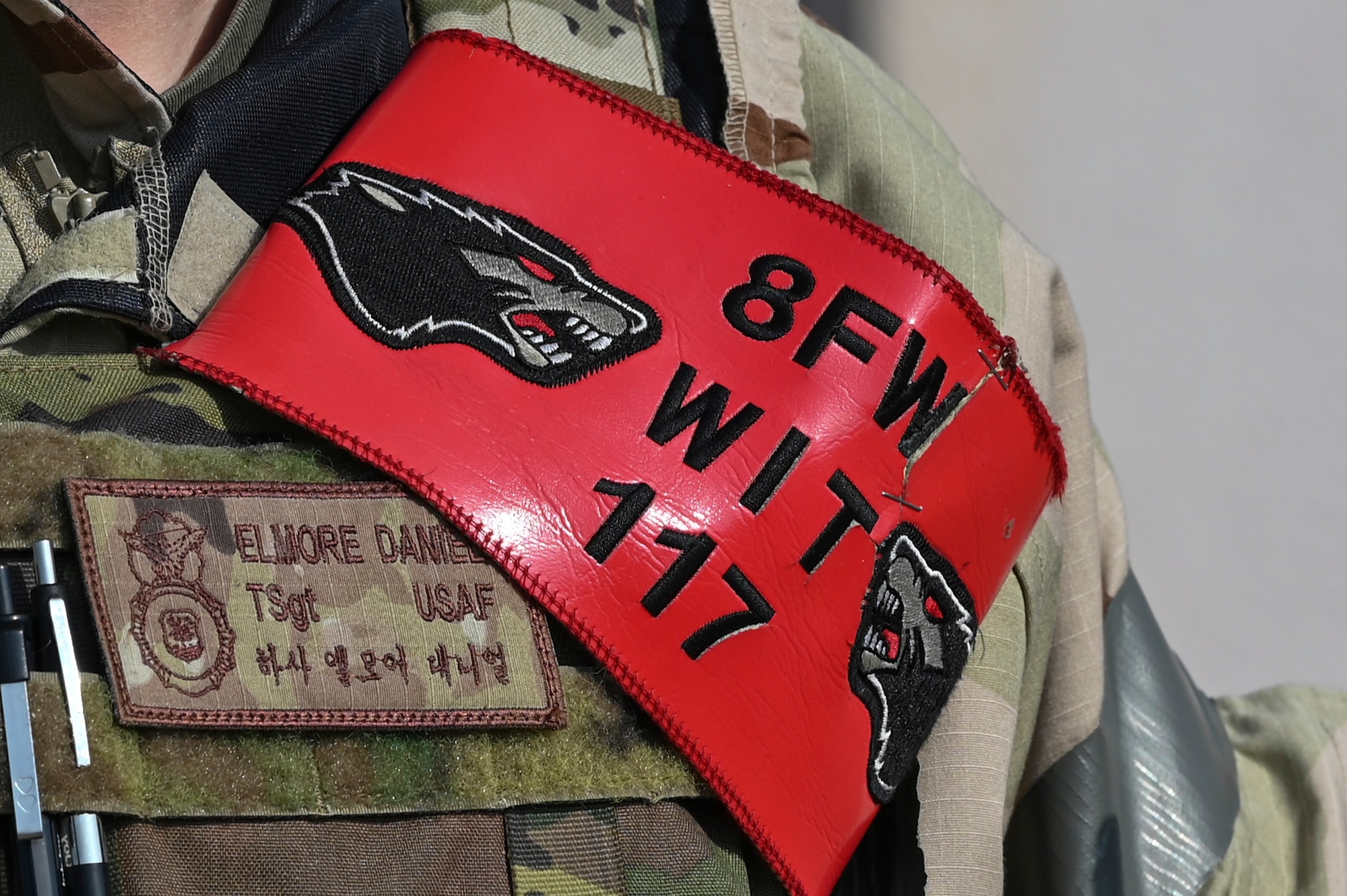 A Wing Inspection Team identifier is fixed to the vest of an 8th Security Forces Squadron member