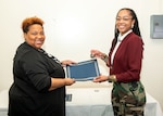 Norfolk Naval Shipyard Contracting Department Business Operation Division Head Donyette Rodgers (left) presents the Contracts Management & Practical Acquisition Skills (CMPAS) Workshop completion certificate to Contract Specialist Chaunsa Saunders. Saunders was one of nine to attend the inaugural 13-week program, which consisted of over 100 hours of academic instruction and 50 hours of hands-on training through mock procurements.