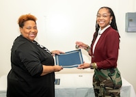 Norfolk Naval Shipyard Contracting Department Business Operation Division Head Donyette Rodgers (left) presents the Contracts Management & Practical Acquisition Skills (CMPAS) Workshop completion certificate to Contract Specialist Chaunsa Saunders. Saunders was one of nine to attend the inaugural 13-week program, which consisted of over 100 hours of academic instruction and 50 hours of hands-on training through mock procurements.