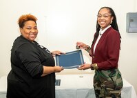 Norfolk Naval Shipyard Contracting Department Business Operation Division Head Donyette Rodgers (left) presents the Contracts Management & Practical Acquisition Skills (CMPAS) Workshop completion certificate to Contract Specialist Chaunsa Saunders. Saunders was one of nine to attend the inaugural 13-week program, which consisted of over 100 hours of academic instruction and 50 hours of hands-on training through mock procurements.