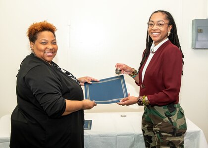 Norfolk Naval Shipyard Contracting Department Business Operation Division Head Donyette Rodgers (left) presents the Contracts Management & Practical Acquisition Skills (CMPAS) Workshop completion certificate to Contract Specialist Chaunsa Saunders. Saunders was one of nine to attend the inaugural 13-week program, which consisted of over 100 hours of academic instruction and 50 hours of hands-on training through mock procurements.
