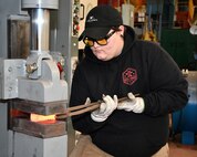 Norfolk Naval Shipyard Metal Forging Shop (Shop 11F) Metal Forger Alejandro “Alex” Beason became interested in blacksmithing when he was about 13-years-old. “A family friend needed a place to store her forge anvil and all the equipment she had,” said Beason. “Once she brought it over and I got a hammer and a pair of tongs in my hand and actually got to start working with pieces of material, I knew I was hooked and stayed with it ever since.”