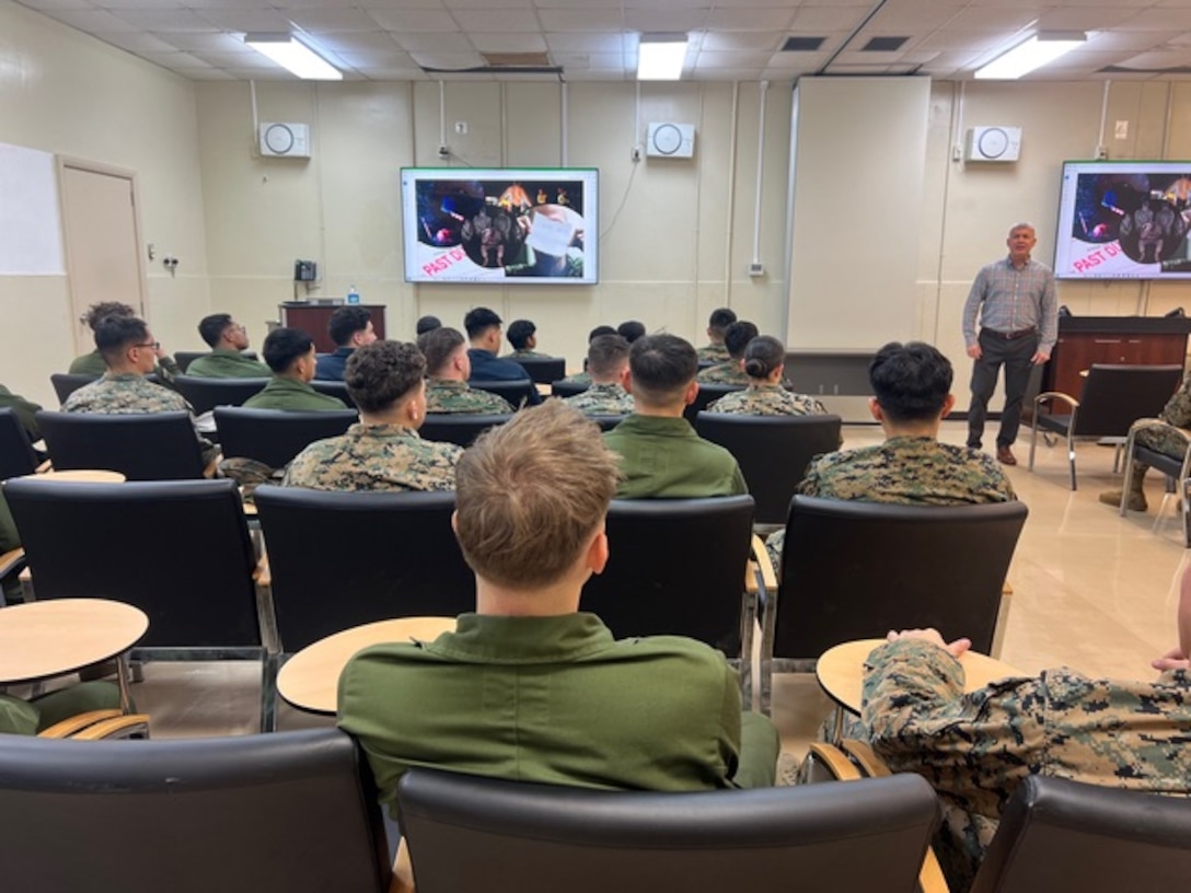 Program Manager James Dollard discusses the complexity of the insider threat problem set with III MEF Marines.