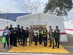 Lt. Col. Khadidja Harrell, flight surgeon with 194th Medical Group, Washington Air National Guard, poses with other medics during the disaster relief and humanitarian assistance exercise Cobra Gold 2025 Feb. 26 – 27 in Chachoengsao Province, Thailand.