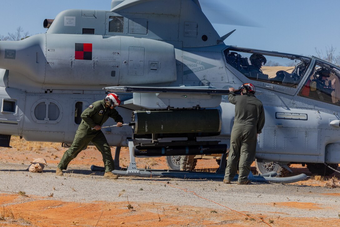 U.S. Marines with Marine Medium Tiltrotor Squadron 263 (Reinforced), 22nd Marine Expeditionary Unit, load 20MM rounds onto an AH-1Z Viper helicopter during Realistic Urban Training (RUT) Exercise on Fort Barfoot, Virginia, March 11, 2025. RUT is a land-based training exercise which enables the 22nd MEU to conduct expeditionary operations as a cohesive Marine Air-Ground Task Force, in preparation to integrate with U.S. Navy for future operations. (U.S. Marine Corps photo by Pfc. Christian Alston)