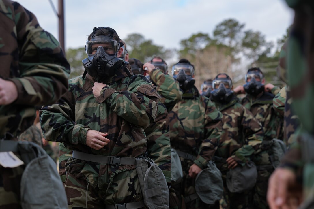 U.S. Marines with Combat Logistics Battalion 24, Combat Logistics Regiment 27, 2nd Marine Logistics Group don mission oriented protective posture equipment (MOPP) during a gas chamber training event on Camp Lejeune, North Carolina, March 11, 2025. Marines with chemical, biological, radiological and nuclear defense conduct gas chamber training annually for Marines and Sailors by exposing them to chlorobenzalmalononitrile tablets, commonly known as CS gas, in order to enhance their efficiency with the M50 gas mask and MOPP equipment. (U.S. Marine Corps photo by Lance Cpl. Franco Lewis)
