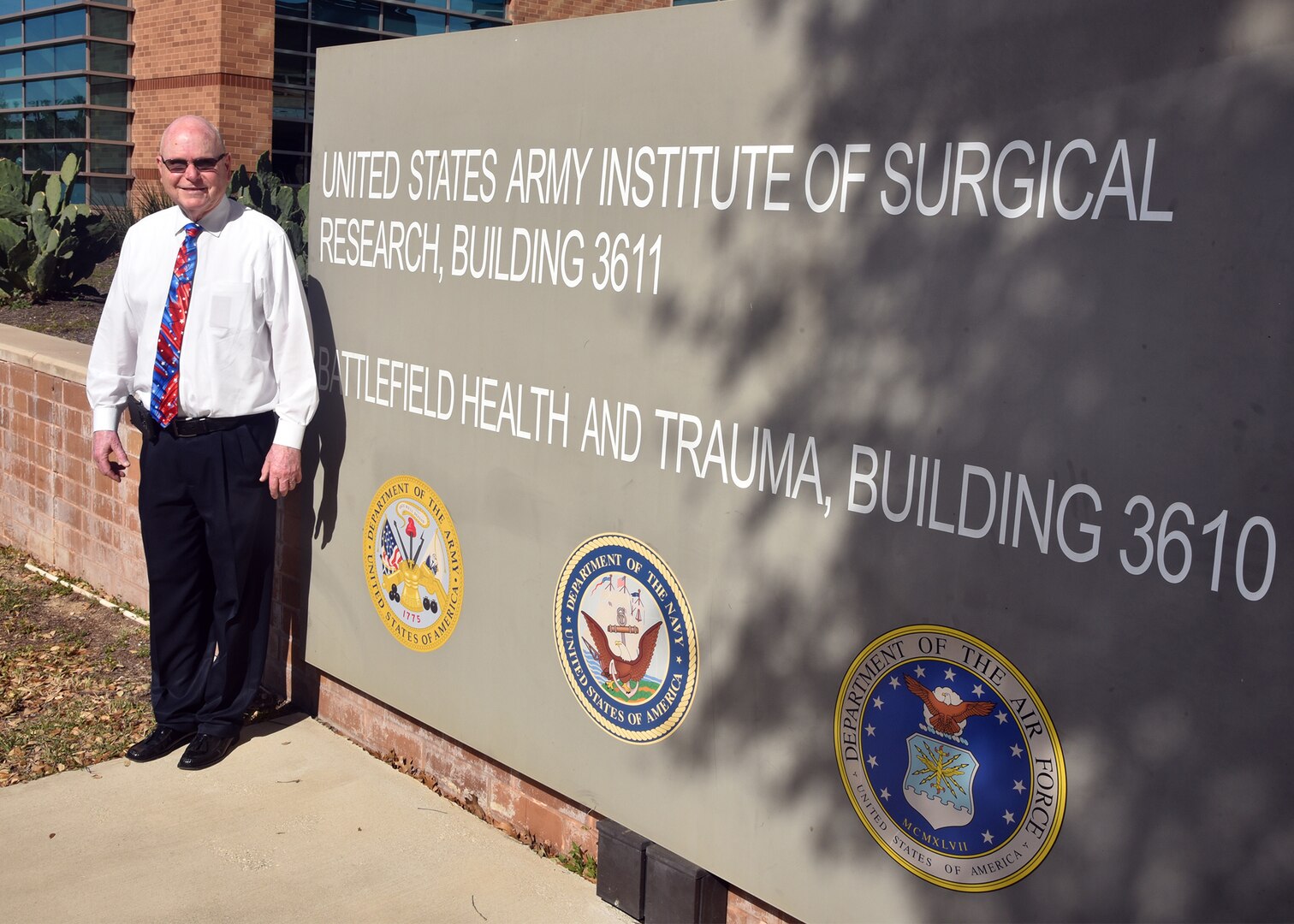 JOINT BASE SAN ANTONIO-FORT SAM HOUSTON – (March 13, 2025) – Dr. John Simecek, director, Craniofacial Health and Restorative Medicine (CHRM), was awarded the Civilian Service Commendation Medal by Naval Medical Research Unit (NAMRU) San Antonio Commanding Officer Capt. Jennifer Buechel, Nurse Corps, during an All Hands Meeting held at the Battlefield Health and Trauma Research Institute. Simecek, a retired Naval dentist, joined the Navy in 1972 serving for 23 years and retired at the rank of lieutenant commander. He joined NAMRU San Antonio in 2009 and has served as the CHRM director for 11 years. He will be retiring from federal service in the fall and will miss the camaraderie. NAMRU San Antonio is one of eight research laboratories within Naval Medicine Research and Development.  Its mission is to conduct gap driven combat casualty care, craniofacial, and directed energy research to improve survival, operational readiness, and safety of Department of Defense personnel engaged in routine and expeditionary operations. (U.S. Navy photo by Burrell Parmer, NAMRU San Antonio Public Affairs/Released)