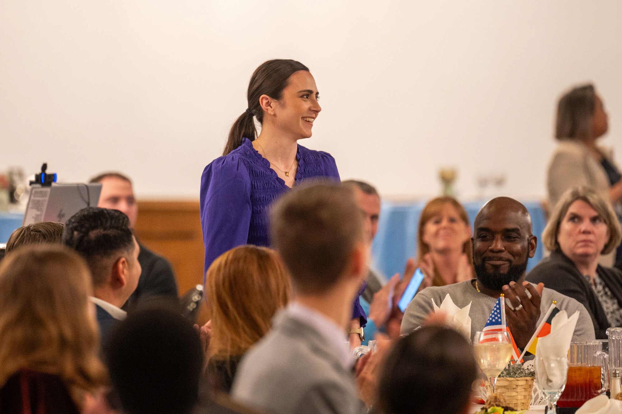 Rachel Arbogast, 86th Force Support Squadron administrative support assistant, stands for a round of applause for her role as a judge during the 2025 European Military Youth of the Year ceremony at Ramstein Air Base, Germany, March 10, 2025. Ramstein hosted the MYOY competition and ceremony for contestants all throughout the U.S. European Command area of responsibility.