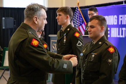 Maj. Gen. Thomas H. Mancino, the adjutant general for Oklahoma, presents Spc. Austin May, an officer candidate with the Southwestern Oklahoma State University Guard Officer Leadership Development program, with the Army Achievement Medal for his heroic actions in saving a fellow GOLD officer candidate’s life during a training exercise, Wednesday, March 12, 2025, in Weatherford, Oklahoma. The actions of May exemplify the values of Citizen-Soldiers and the Oklahoma National Guard, highlighting their valor, readiness and selfless community service. (Oklahoma National Guard photo by Sgt. Tyler Brahic)