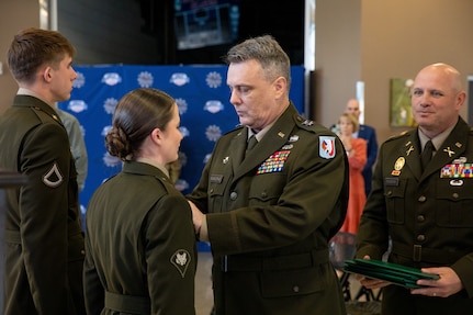 Maj. Gen. Thomas H. Mancino, the adjutant general for Oklahoma, presents Spc. Avrie Nowakowski, an officer candidate with the Southwestern Oklahoma State University Guard Officer Leadership Development program, with the Army Achievement Medal for her heroic actions in saving a fellow GOLD officer candidate’s life during training exercise, Wednesday, March 12, 2025, in Weatherford, Oklahoma. The actions of Nowakowski exemplify the values of Citizen-Soldiers and the Oklahoma National Guard, highlighting their valor, readiness and selfless community service. (Oklahoma National Guard photo by Sgt. Tyler Brahic)