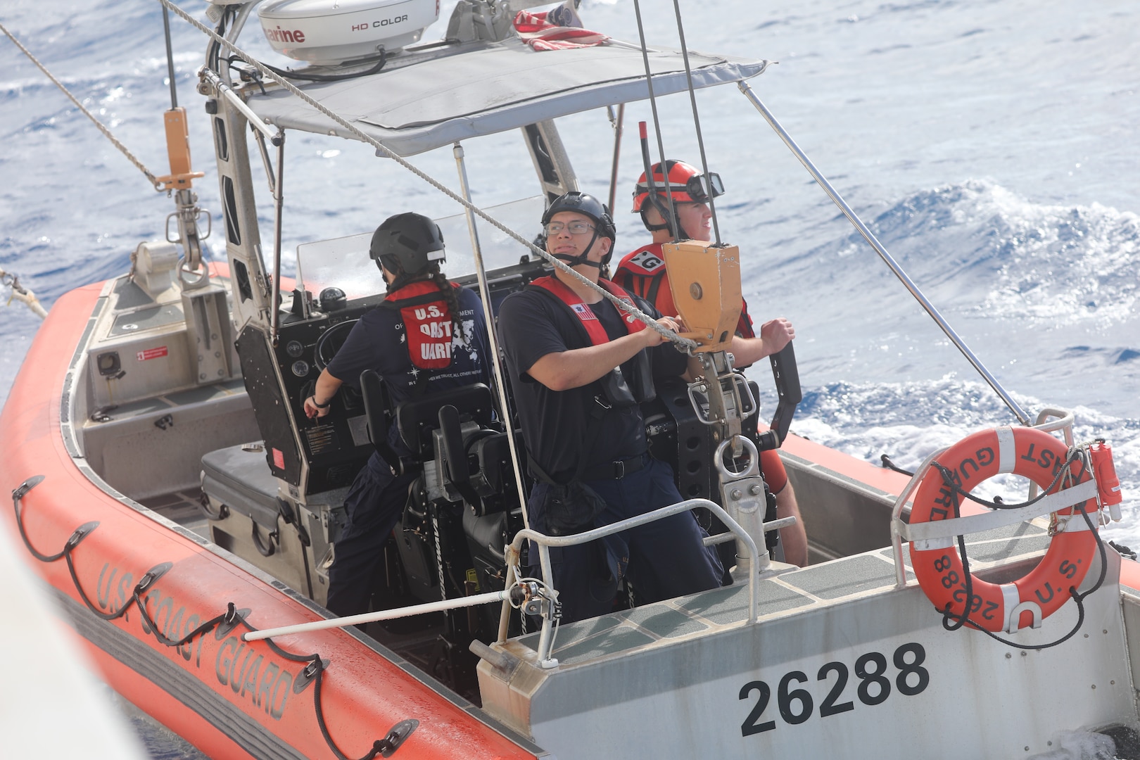 Crew members assigned to Coast Guard Cutter Reliance (WMEC 615) are lowered by the ship's davit for small boat operations in the Florida Straits, Jan. 31, 2025. Reliance conducted a 60-day patrol in the Florida Straits, Windward Passage and Gulf of America to safeguard U.S. maritime borders. (U.S. Coast Guard photo by Ensign Sarah Kaleta)