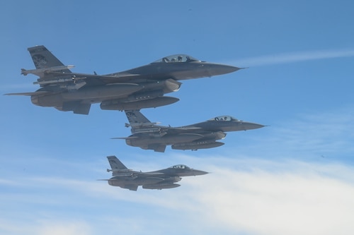 Three military jets fly.