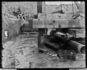 This photograph from November 9, 1904 shows a closeup view of the first piling as the crew works to sink the second.