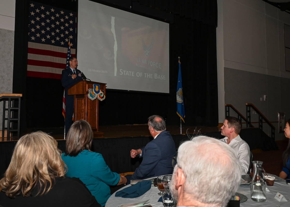 A man in a military dress uniform speaks to a crowd.