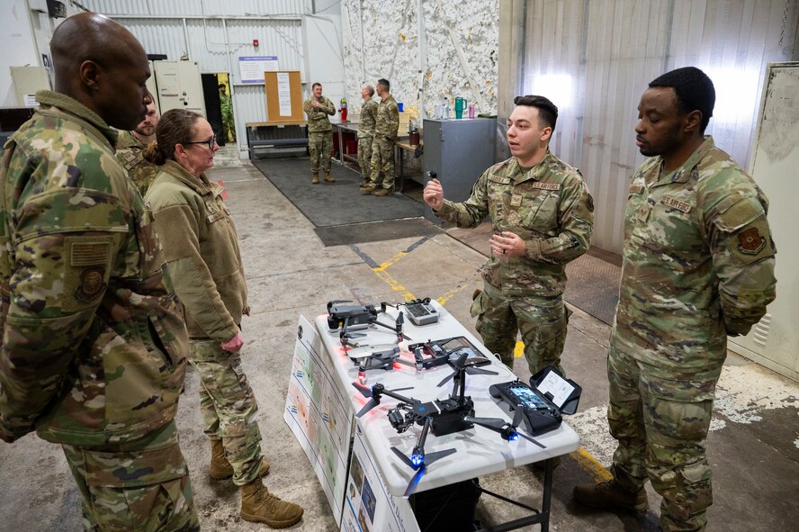 U.S. Air Force Maj. Gen. Stacy Jo Huser, the 20th Air Force Commander, and Chief Master Sgt. Nicholas Taylor, the 20th Air Force Command Chief Master Sergeant, listen to a presentation about unmanned aircraft systems by Senior Airman Christopher Isola, an air defense technician from the 91st Missile Security Operations Squadron at Minot Air Force Base, North Dakota, March 11, 2025. Small unmanned aircraft systems amplify security responses and site security. (U.S. Air Force photo by Senior Airman Kendra A. Ransum)