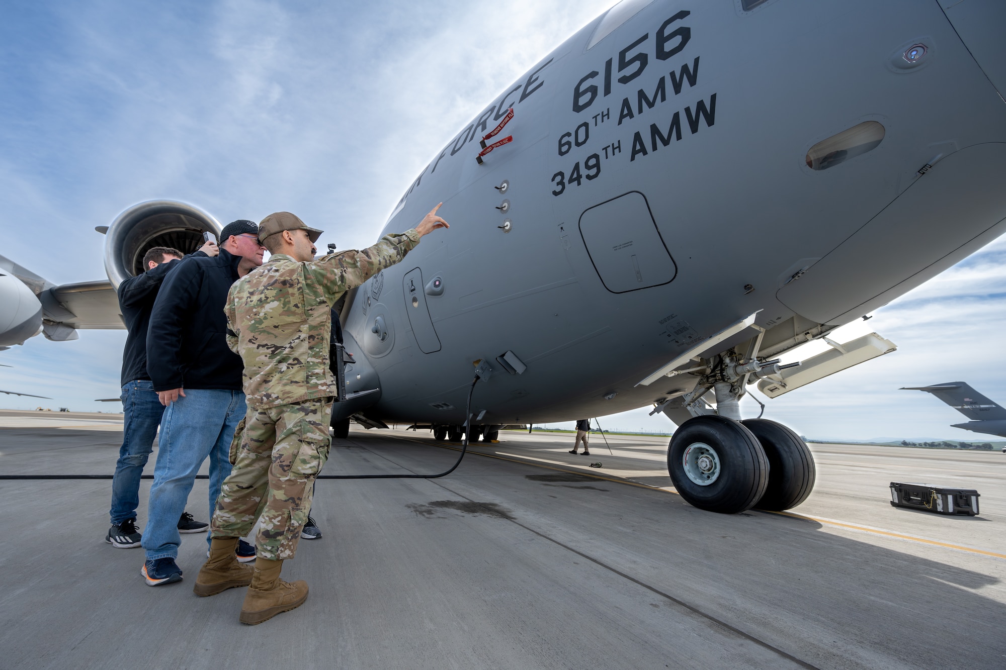 An Airman explains antenna radiation hazards on a C-17 Globemaster III to members of Mass Virtual