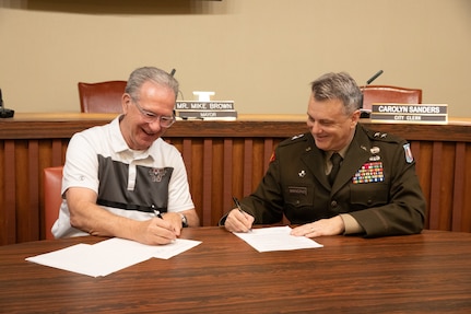 Mayor Mike Brown, mayor of the city of Weatherford and Maj. Gen. Thomas H. Mancino, adjutant general for Oklahoma, sign a memorandum of understanding fostering greater cooperation between the city and the Oklahoma National Guard during a ceremony at the Weatherford city hall in Weatherford, Oklahoma, March 12, 2025. (Oklahoma National Guard photo by Sgt. Tyler Brahic)