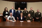 (front row, left to right) Mayor Mike Brown, mayor of Weatherford, Oklahoma, Dr. Diana Lovell, Southwestern Oklahoma State University president, and Maj. Gen. Thomas H. Mancino, adjutant general for Oklahoma, gather after signing agreements at Weatherford city hall in Weatherford, Oklahoma, March 12, 2025. The ceremony celebrated the signing of agreements, fostering cooperation between the city, university and the Oklahoma National Guard. (Oklahoma National Guard photo by Sgt. Tyler Brahic)