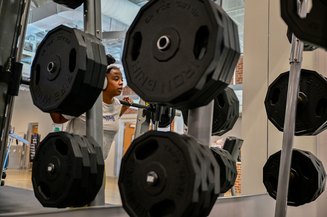 Woman in exercise gear lifts weight