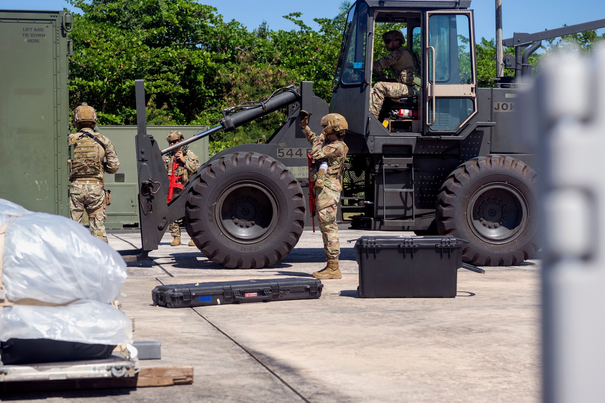 U.S. Airmen with the 156th Contingency Response Group, Puerto Rico Air National Guard, work together to move cargo with a 10k all terrain forklift during a Mothball 2 Combat Readiness Exercise at Muñiz Air National Guard Base, Carolina, Puerto Rico, March 8, 2025. CR Airmen trained to deploy to a contingency location and establish runway operations to receive and dispatch cargo and aircrafts in a contested environment. (U.S. Air National Guard photo by Senior Airman Marrissa Rodriguez)