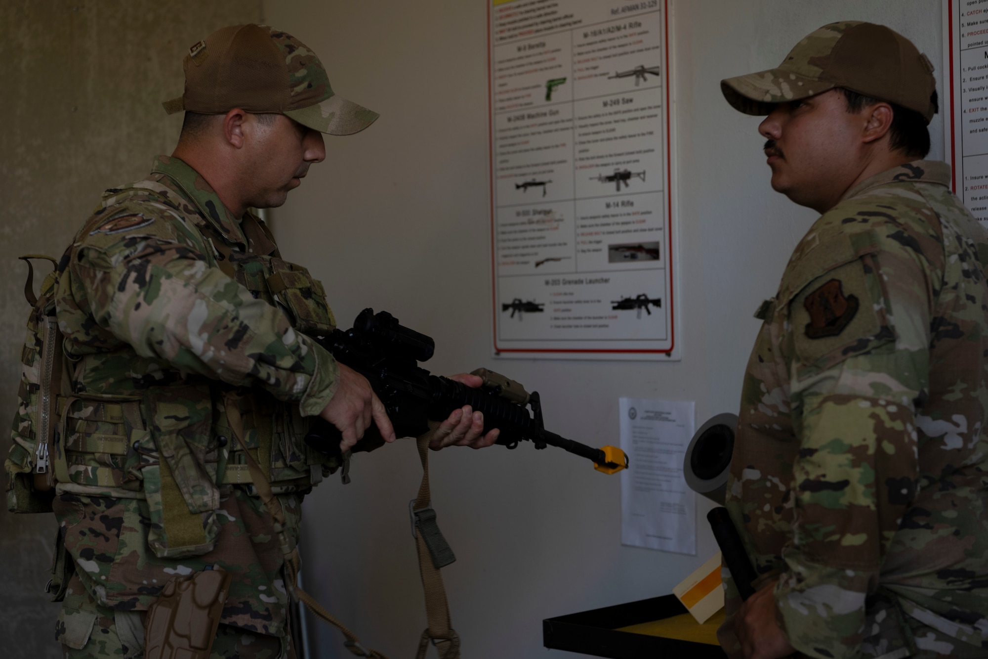 U.S. Air Force Tech. Sgt. Orlando Quiones, a security forces craftsman with the 156th Contingency Response Group, Puerto Rico Air National Guard, performs weapon clearing procedures during Mothball 2 Combat Readiness Exercise at Muñiz Air National Guard Base, Carolina, Puerto Rico, March 7, 2025. Mothball 2 measured  the 156th Wing’s ability to generate, employ and sustain contingency response capabilities in a full war-fighting scenario, increasing readiness and force lethality. (U.S. Air National Guard photo by Senior Airman Victoria Jewett)
