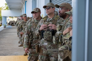 U.S. Airmen assigned to the 156th Contingency Response Group, Puerto Rico Air National Guard, listen to instructions for tactical gear issue during Mothball 2 Combat Readiness Exercise at Muñiz Air National Guard Base, Carolina, Puerto Rico, March 7, 2025. Mothball 2 measured  the 156th Wing’s ability to generate, employ and sustain contingency response capabilities in a full war-fighting scenario, increasing readiness and force lethality. (U.S. Air National Guard photo by Senior Airman Victoria Jewett)