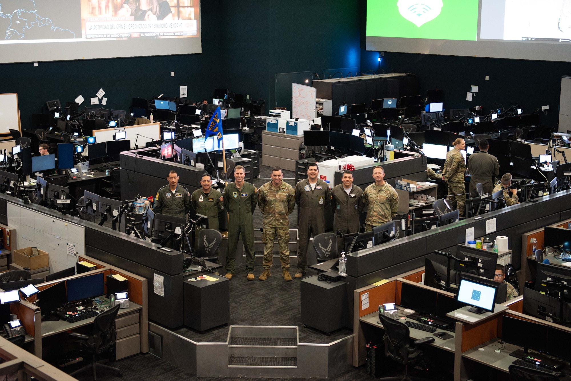 Maj. Gen. David Mineau, Air Forces Southern (AFSOUTH) commander, center-left, and Col. Donald Morris, 612th Air Operations Center (AOC) commander, far-right, pose for a group photo with AFSOUTH Liaison Officers at Davis-Monthan Air Force Base, Arizona, March 5, 2025. The briefing marked phase one for the Liaison Officers from Argentina, Brazil, Chile, Colombia, Ecuador, and Peru, joining U.S. Air Force personnel at the 612th AOC, marking a significant milestone in coalition air power coordination. (U.S. Air Force photo by Master Sgt. Kenneth New)