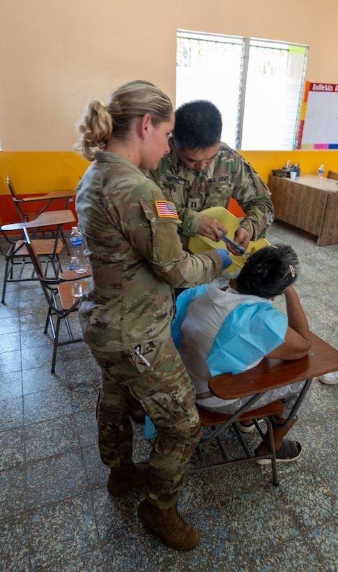 Two U.S. Army personnel perform a procedure on a patient during a JTF-Bravo medical mission in La Paz, Honduras, March 12, 2025. These medical missions have become a hallmark of JTF-Bravo's enduring legacy in the region, demonstrating their unwavering dedication to building a stronger and more resilient Honduras and Central America. (U.S. Army courtesy photo)