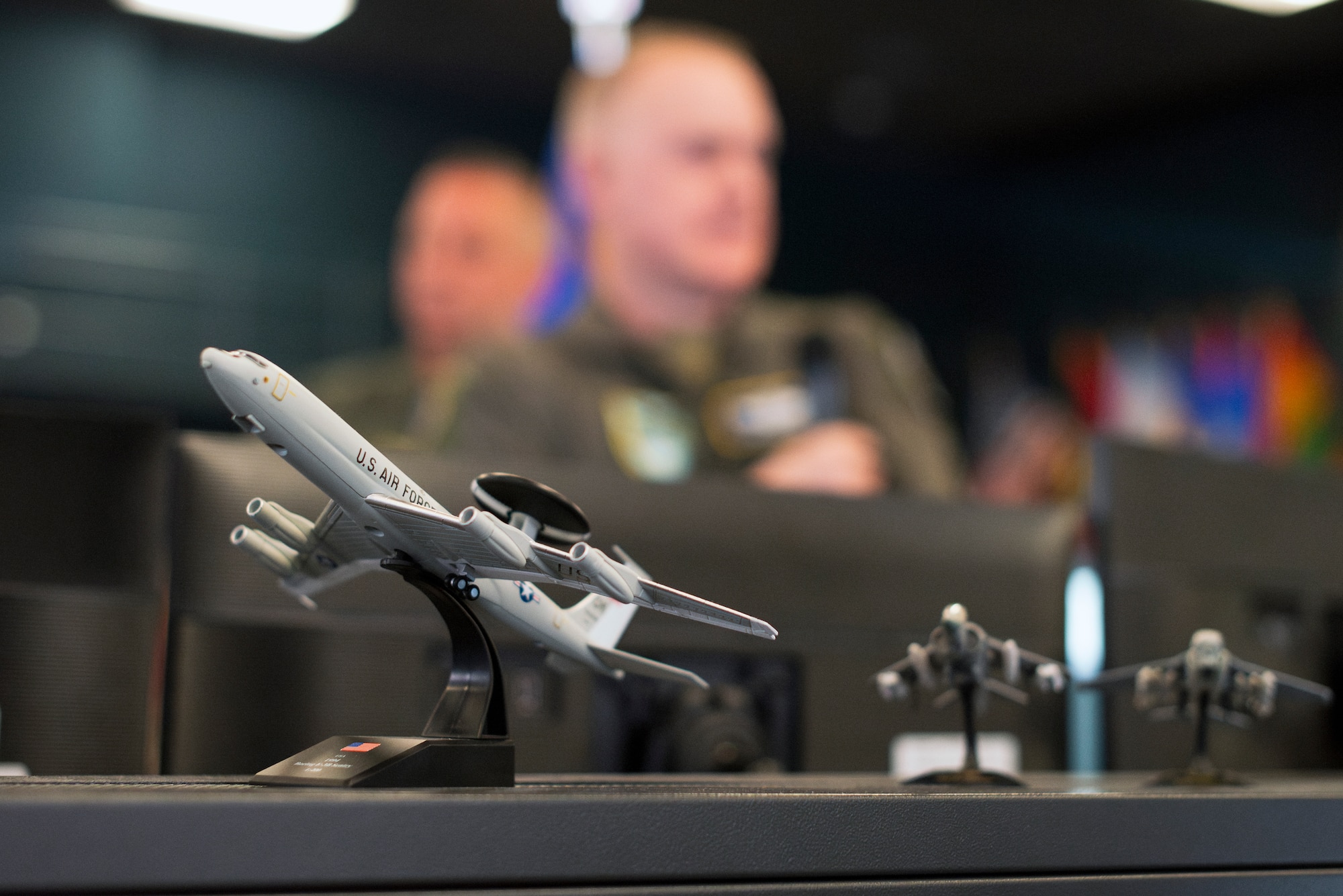 An E-3 Sentry Airborne Warning and Control System model aircraft sits on a desk at the 612th Air Operations Center (AOC) on Davis-Monthan Air Force Base, Arizona, March 14, 2025. The briefing marked phase two for the Liaison Officers from Argentina, Brazil, Chile, Colombia, Ecuador, and Peru, joining U.S. Air Force personnel at the 612th AOC, marking a significant milestone in coalition air power coordination. (U.S. Air Force photo by Tech. Sgt. Rachel Maxwell)