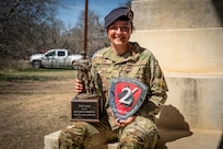 Airman poses for photo with two MWD handler awards