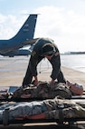 Staff Sgt. Evan Johnson, a Reserve Citizen Airman assigned to the 433rd Airlift Wing, prepares medical supplies and training equipment inside during an aeromedical evacuation exercise onboard Naval Station (NAVSTA) Rota, Spain, March 10, 2025.