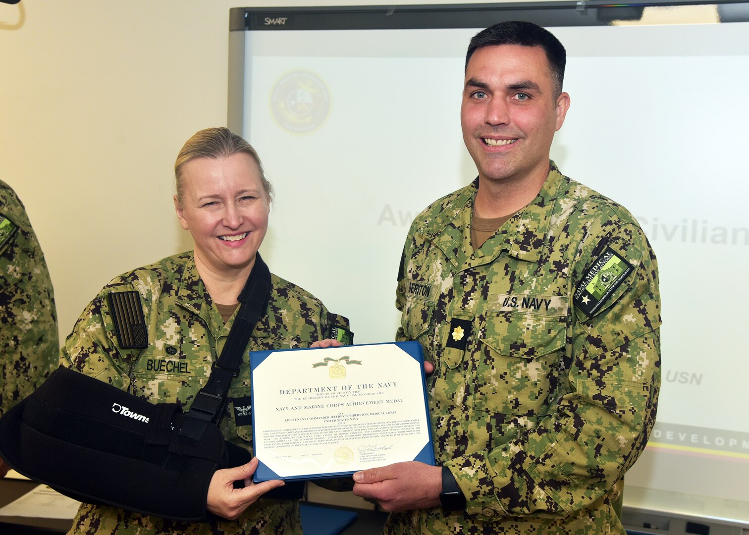 JOINT BASE SAN ANTONIO-FORT SAM HOUSTON – (March 13, 2025) – Lt. Cmdr. Jeffrey Biberston, Medical Corps, of Casper, Wyo., department head, Expeditionary and Trauma Medicine, was awarded the Navy and Marine Corps Achievement Medal by Naval Medical Research Unit (NAMRU) San Antonio Commanding Officer Capt. Jennifer Buechel during an All Hands Meeting held at the Battlefield Health and Trauma Research Institute. Biberston, was recently selected as NAMRU San Antonio’s Junior Officer of the Year for 2024 and is the only Pulmonary and Critical Care physician currently serving within Naval Medicine Research and Development (NMR&D). NAMRU San Antonio is one of eight research laboratories within NMR&D. Its mission is to conduct gap driven combat casualty care, craniofacial, and directed energy research to improve survival, operational readiness, and safety of Department of Defense personnel engaged in routine and expeditionary operations. (U.S. Navy photo by Burrell Parmer, NAMRU San Antonio Public Affairs/Released)