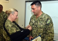 JOINT BASE SAN ANTONIO-FORT SAM HOUSTON – (March 13, 2025) – Lt. Cmdr. Jeffrey Biberston, Medical Corps, of Casper, Wyo,, epartment head, Expeditionary and Trauma Medicine, was awarded the Navy and Marine Corps Achievement Medal by Naval Medical Research Unit (NAMRU) San Antonio Commanding Officer Capt. Jennifer Buechel during an All Hands Meeting held at the Battlefield Health and Trauma Research Institute. Biberston, was recently selected as NAMRU San Antonio’s Junior Officer of the Year for 2024 and is the only Pulmonary and Critical Care physician currently serving within Naval Medicine Research and Development (NMR&D). NAMRU San Antonio is one of eight research laboratories within NMR&D. Its mission is to conduct gap driven combat casualty care, craniofacial, and directed energy research to improve survival, operational readiness, and safety of Department of Defense personnel engaged in routine and expeditionary operations. (U.S. Navy photo by Burrell Parmer, NAMRU San Antonio Public Affairs/Released)