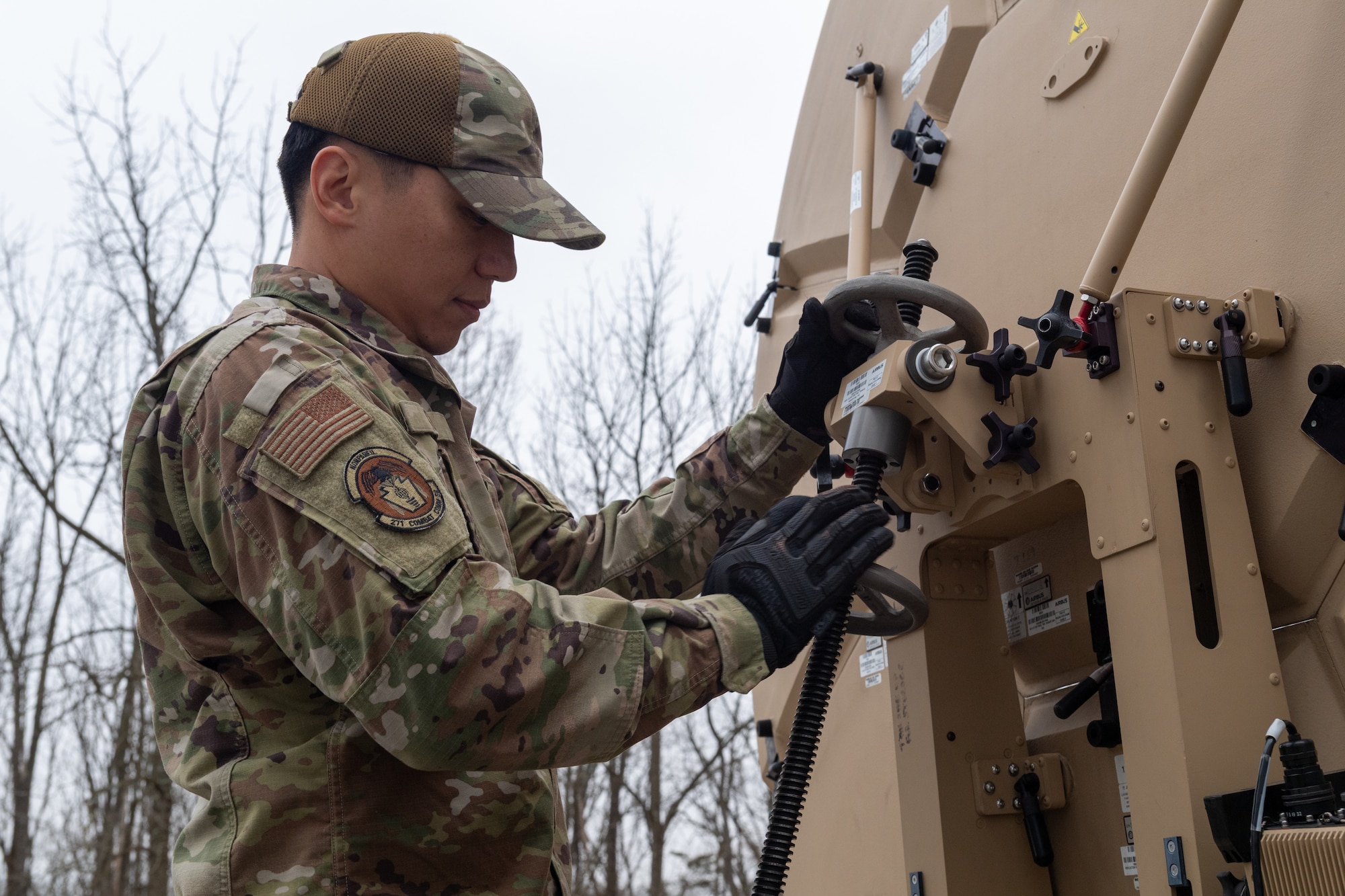 Airman 1st Class Sang Kim, radio frequency transmission systems specialist with the 271st Combat Communications Squadron, repositions an Airbus Ranger 2400 satellite antenna due to projected severe weather, March 15, 2025.