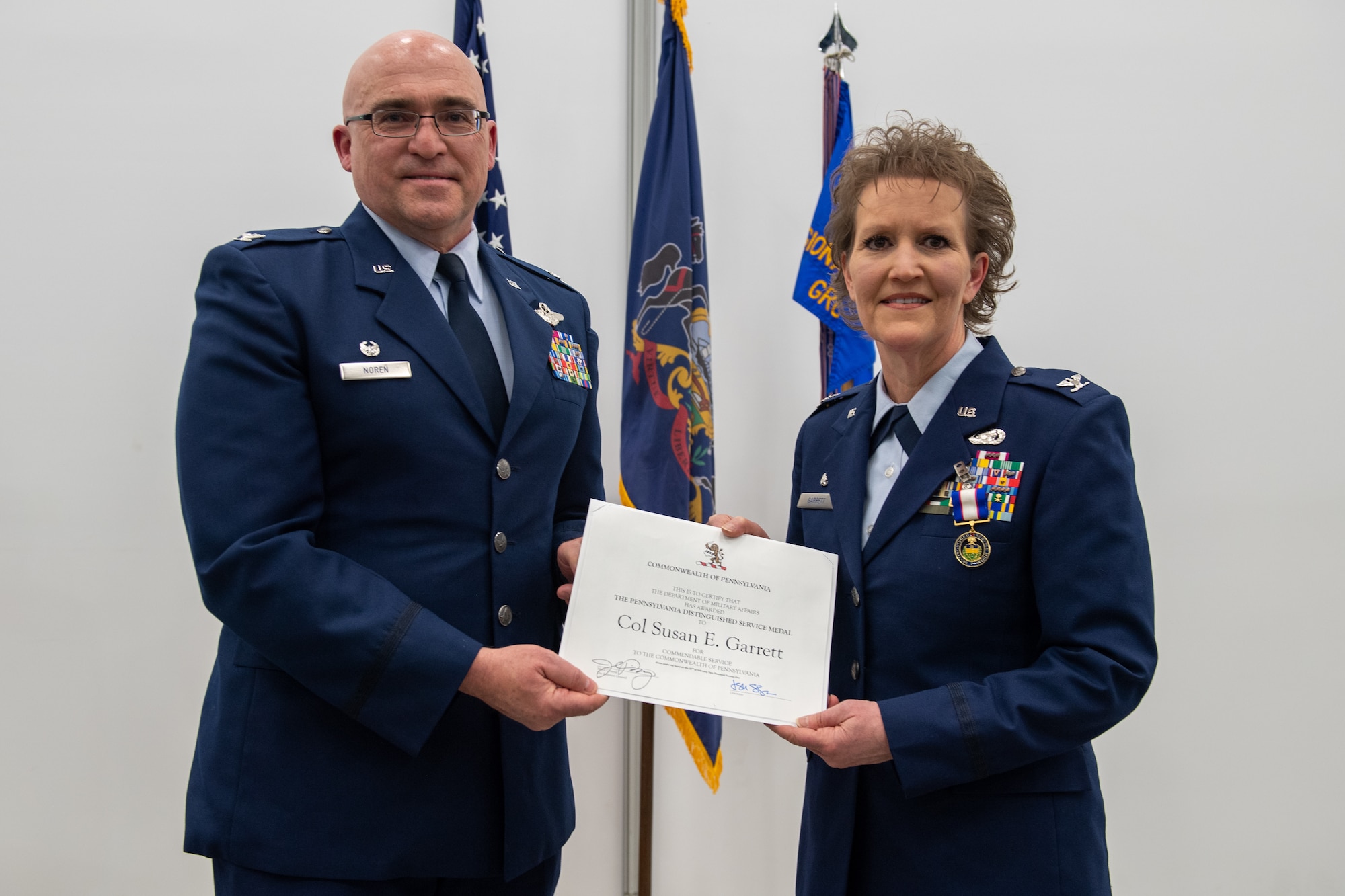 Col. Robert Noren (left), 193rd Special Operations Wing commander, presents Col. Susan Garrett, 193rd Regional Support Group commander, with the Pennsylvania Distinguished Service Medal during her retirement ceremony held March 15, 2025.