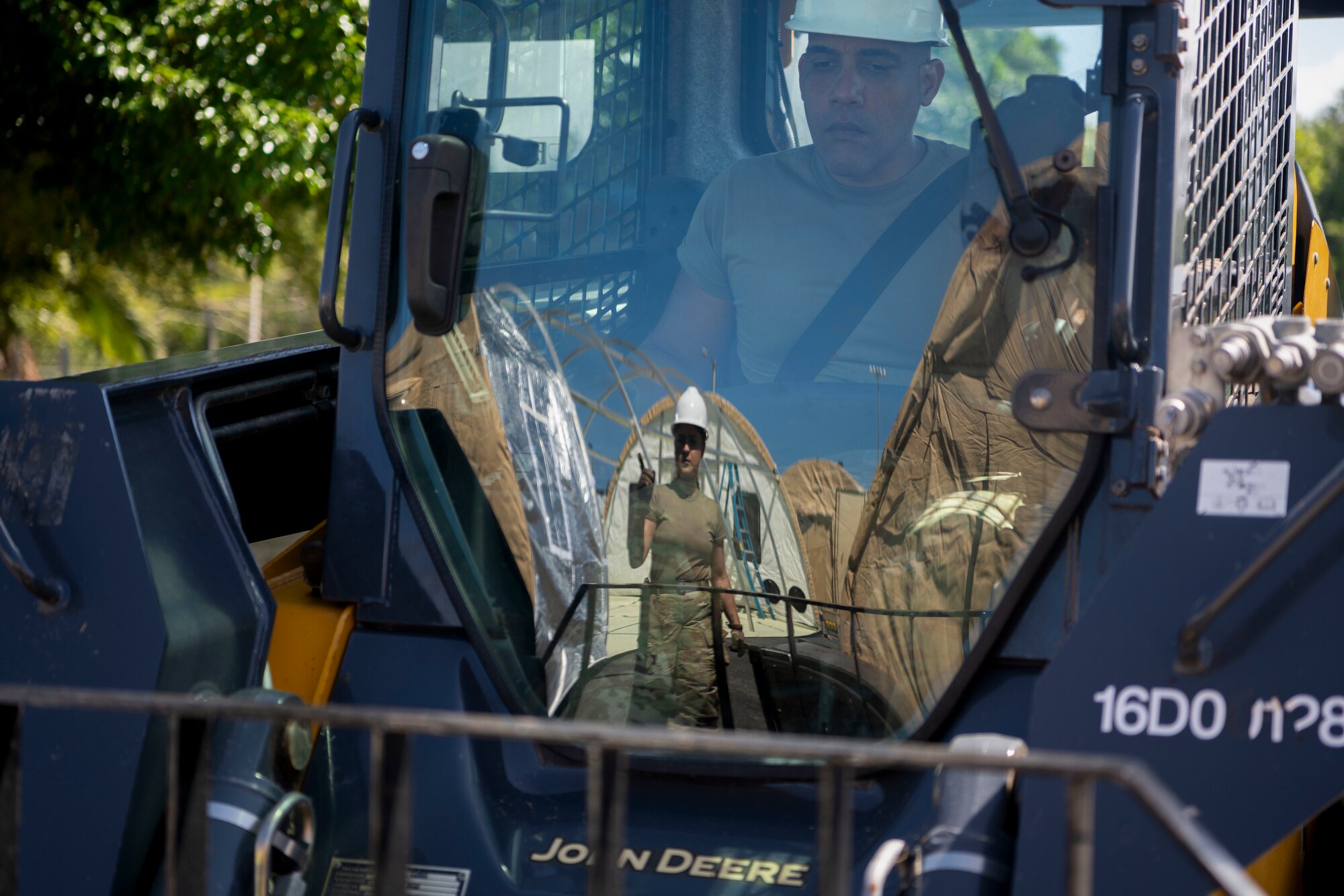 U.S. Air Force Tech. Sgt. Juan Diaz, a heating and ventilation air conditioning craftsman with the 156th Civil Engineer Squadron, Puerto Rico Air National Guard, operates a compact track loader during a Disaster Relief Beddown System build up at Muñiz Air National Guard Base, Carolina, Puerto Rico, Feb. 27, 2025. The 156th CES Airmen assembled the DRBS, a system with the capacity to shelter 150 people in case of a disaster as a training opportunity in preparation for the March regularly scheduled drill. (U.S. Air National Guard photo by Master Sgt. Rafael D. Rosa)