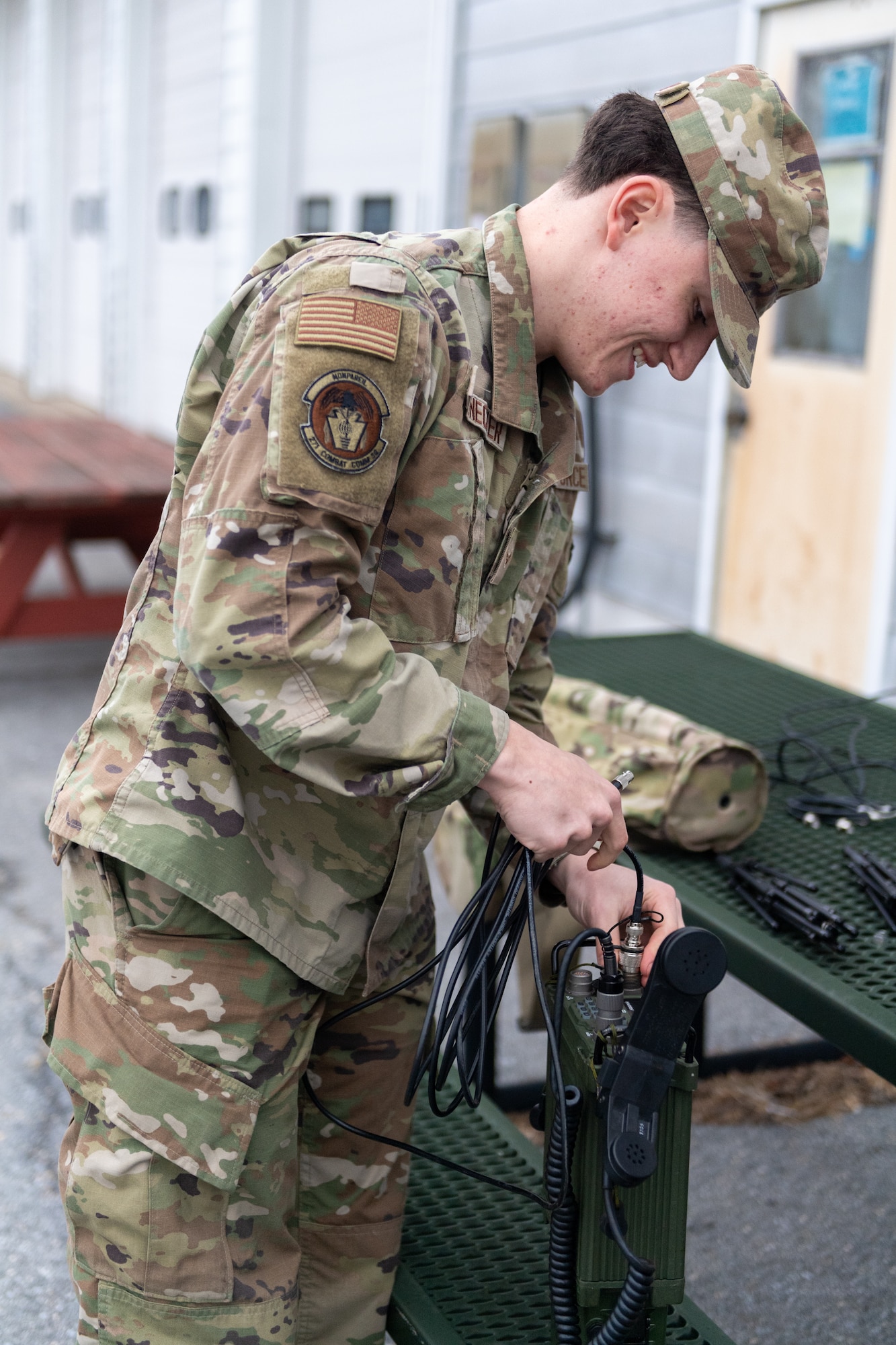 Airman 1st Class Benjamin Stalnecker, radio frequency transmission systems specialist with the 271st Combat Communications Squadron, assembles an AV2040 high-gain ultra high frequency satellite communications antenna connected to an AN/PRC-117G multiband networking radio, which enables secure voice and data communications through a geostationary satellite for the warfighter, March 15, 2025.