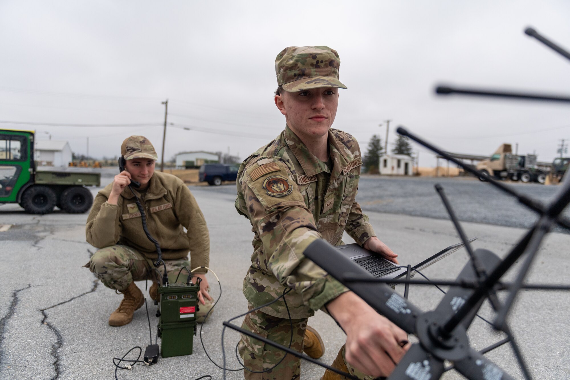 Staff Sgt. Ethan Turner (left) and Airman 1st Class Benjamin Stalnecker, radio frequency transmission systems specialists with the 271st Combat Communications Squadron, assemble an AV2040 high-gain ultra high frequency satellite communications antenna connected to an AN/PRC-117G multiband networking radio which enables secure voice and data communications through a geostationary satellite for the warfighter, March 15, 2025.